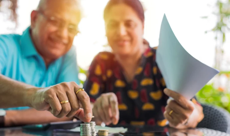 Senior Indian couple saving money by removing tax penalties with penalty abatement services by American Tax Service